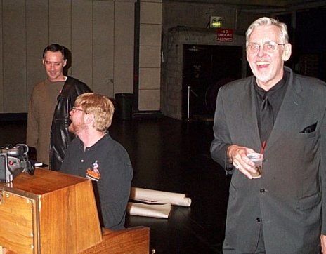 Jim Brochu laughs at the piano.