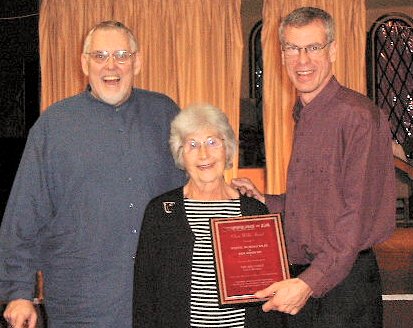 Jimy and Steve holding the red plaque. Bea between us.