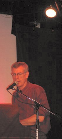 Steve Schalchlin singing at the piano.