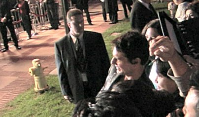 Tom Cruise poses with fans.